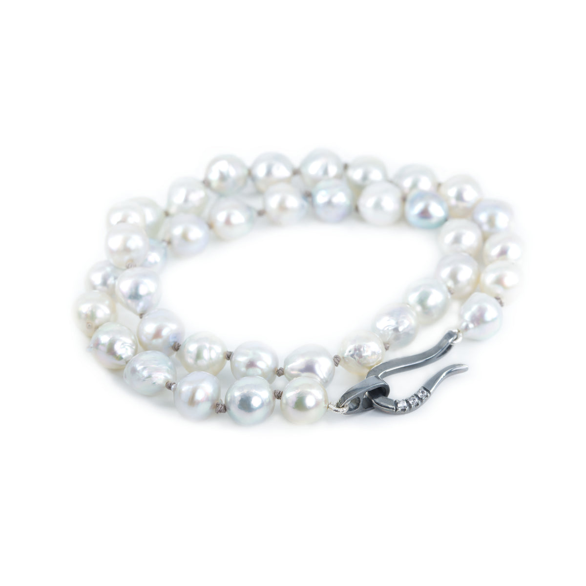 Akoya pearl necklace featured on the white background. The necklace is finished with blackened sterling silver hook clasp.