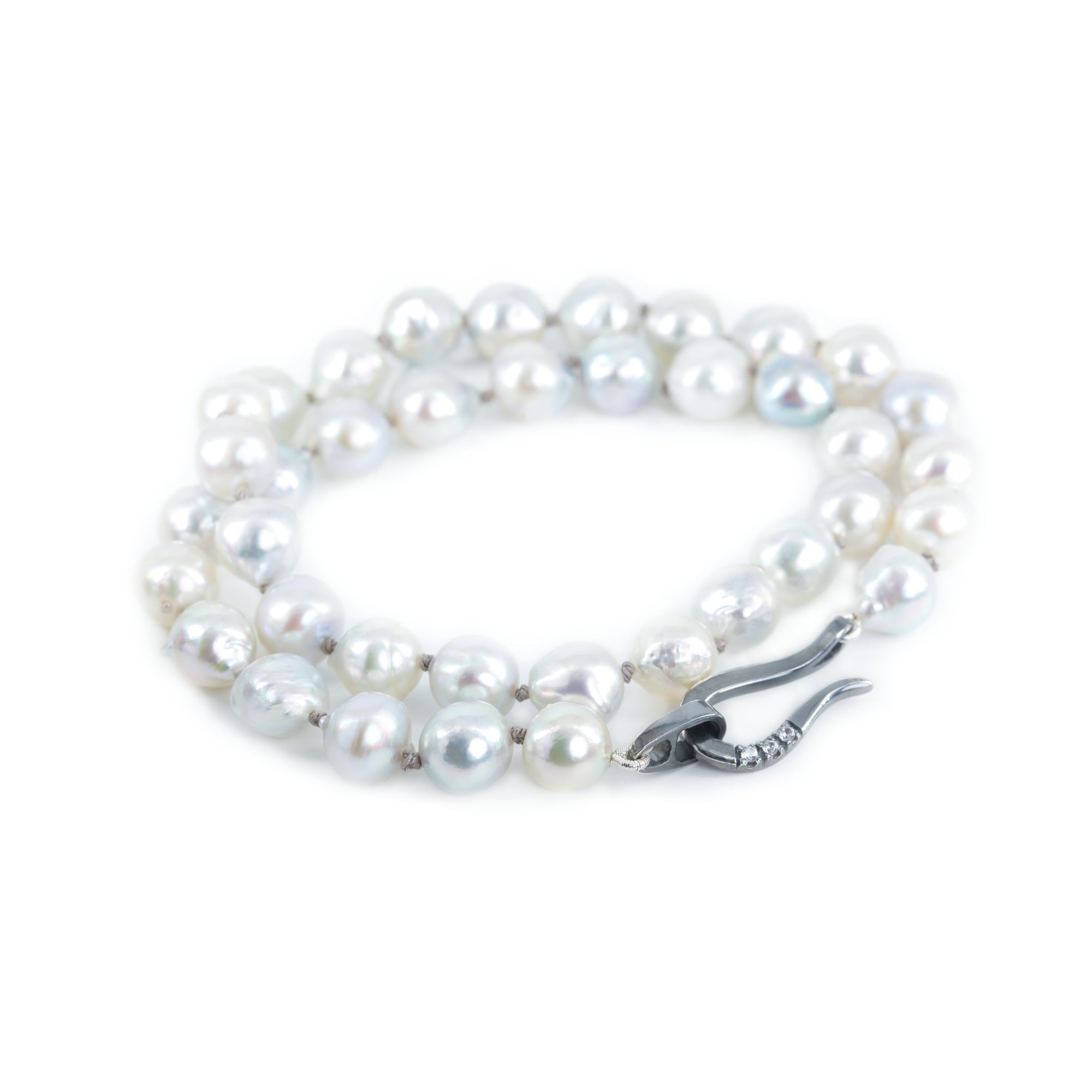 Akoya pearl necklace featured on the white background. The necklace is finished with blackened sterling silver hook clasp.