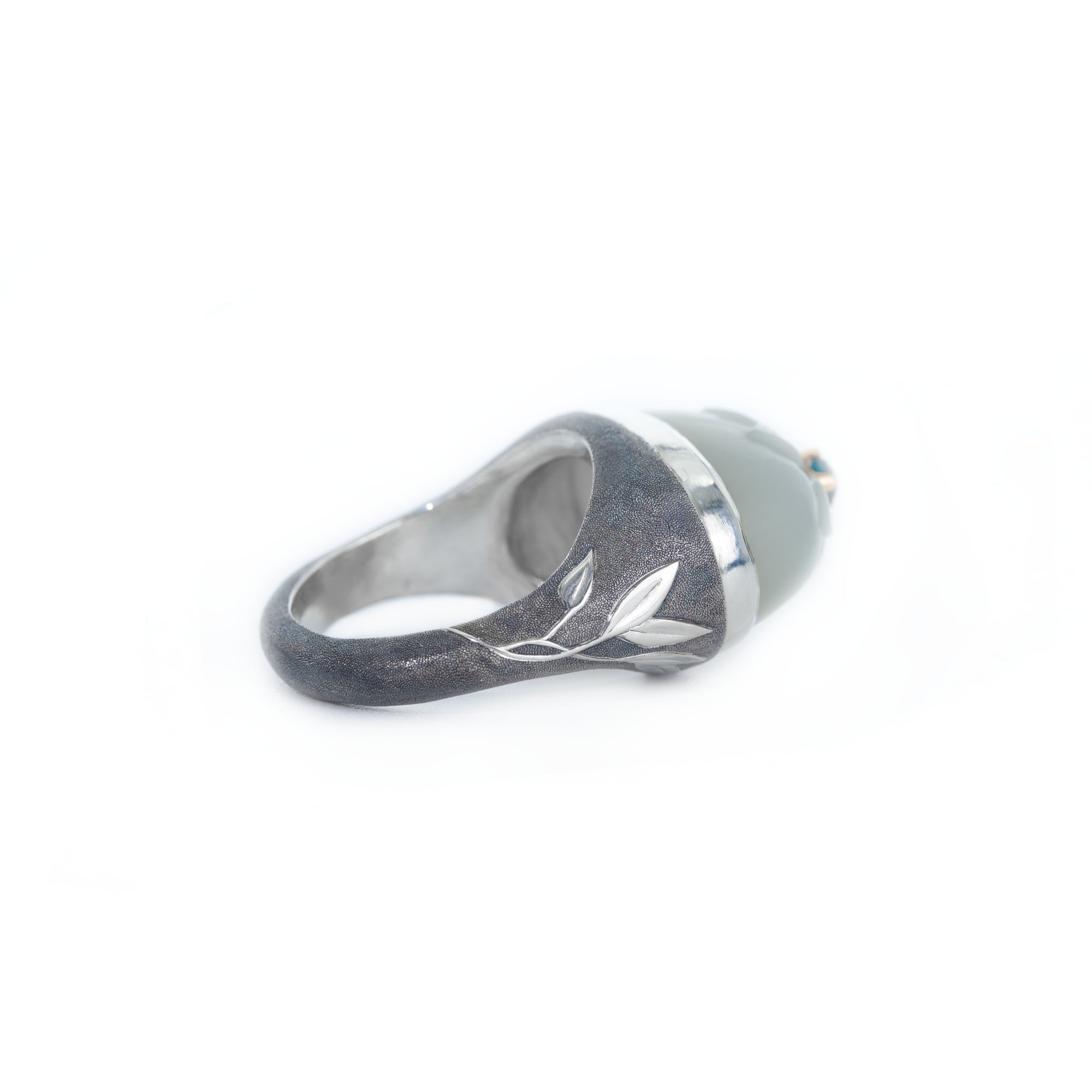 Silver ring with leaf design on a white background