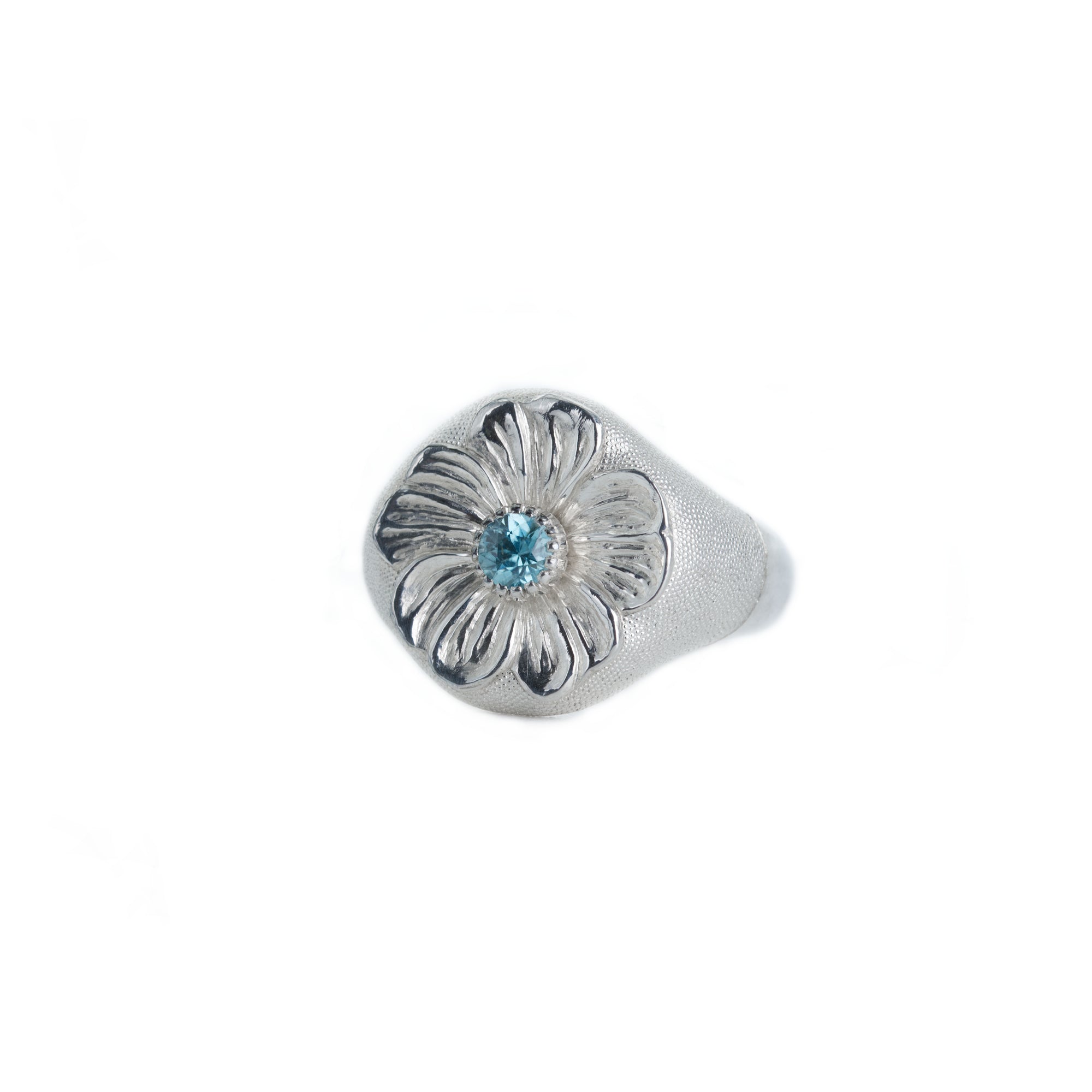 Silver ring with a blue gemstone on a white background