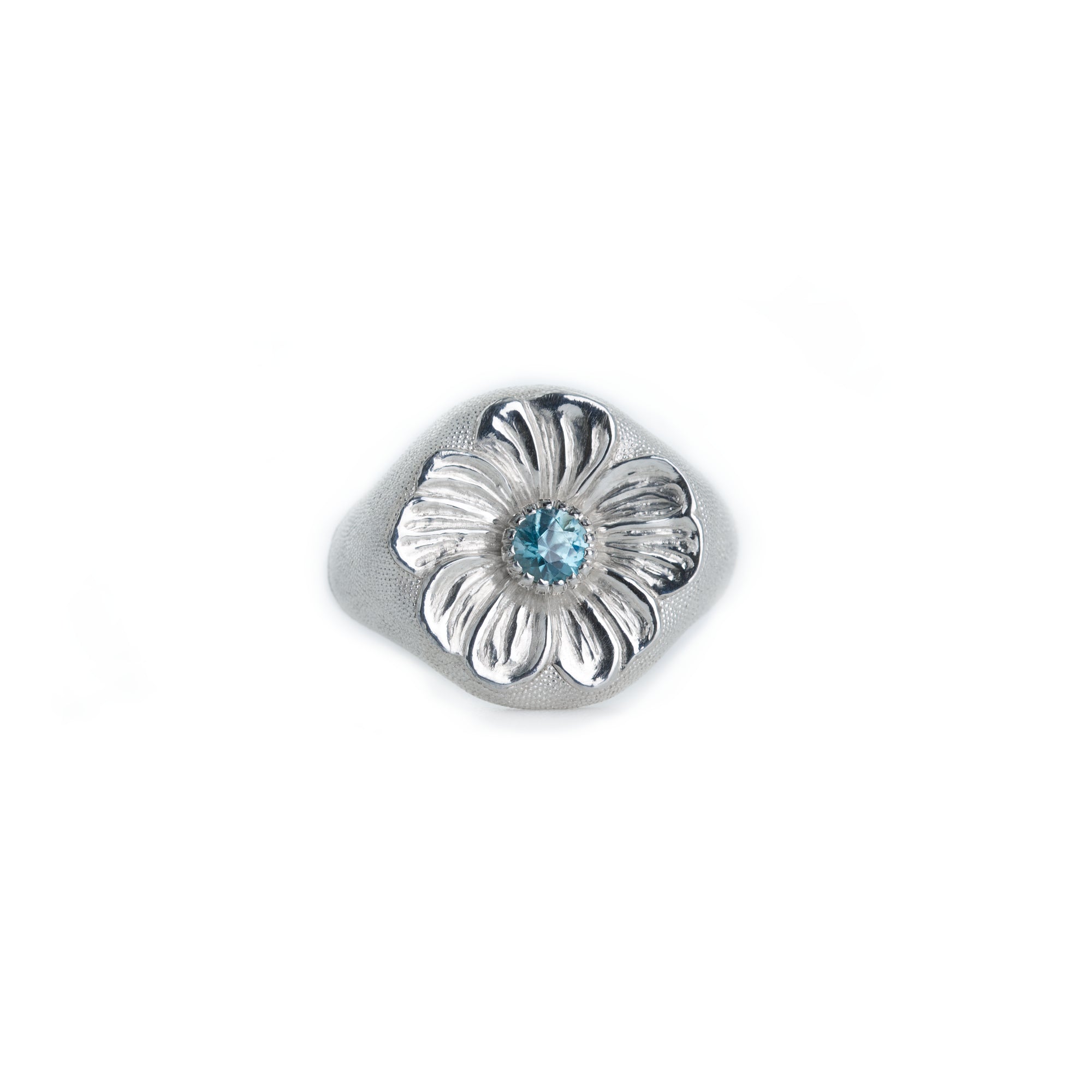 Silver floral signet ring with a blue gemstone on a white background