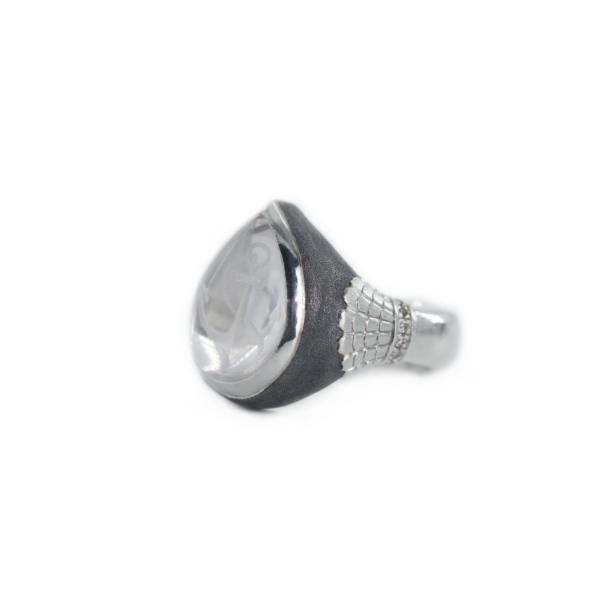 Silver and black signet ring on a white background