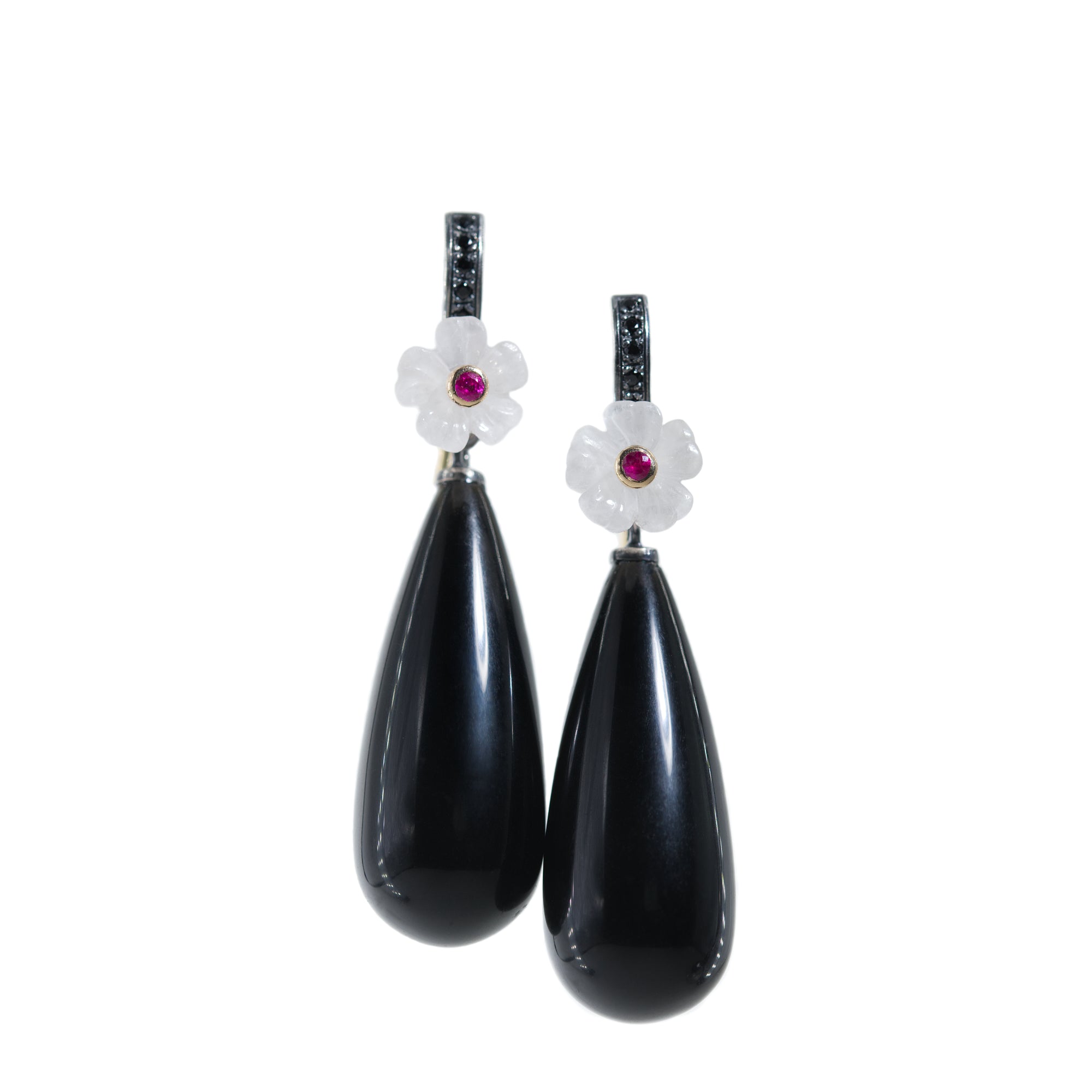 Pair of black teardrop earrings with floral tops featuring red gemstones on a white background