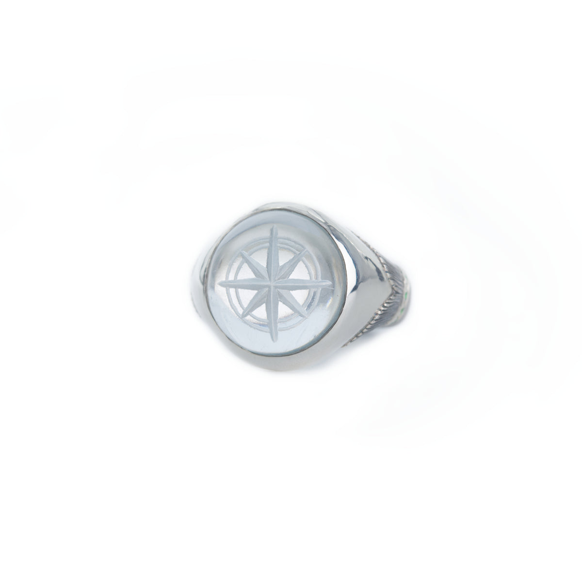 Silver ring with a compass design on a white background