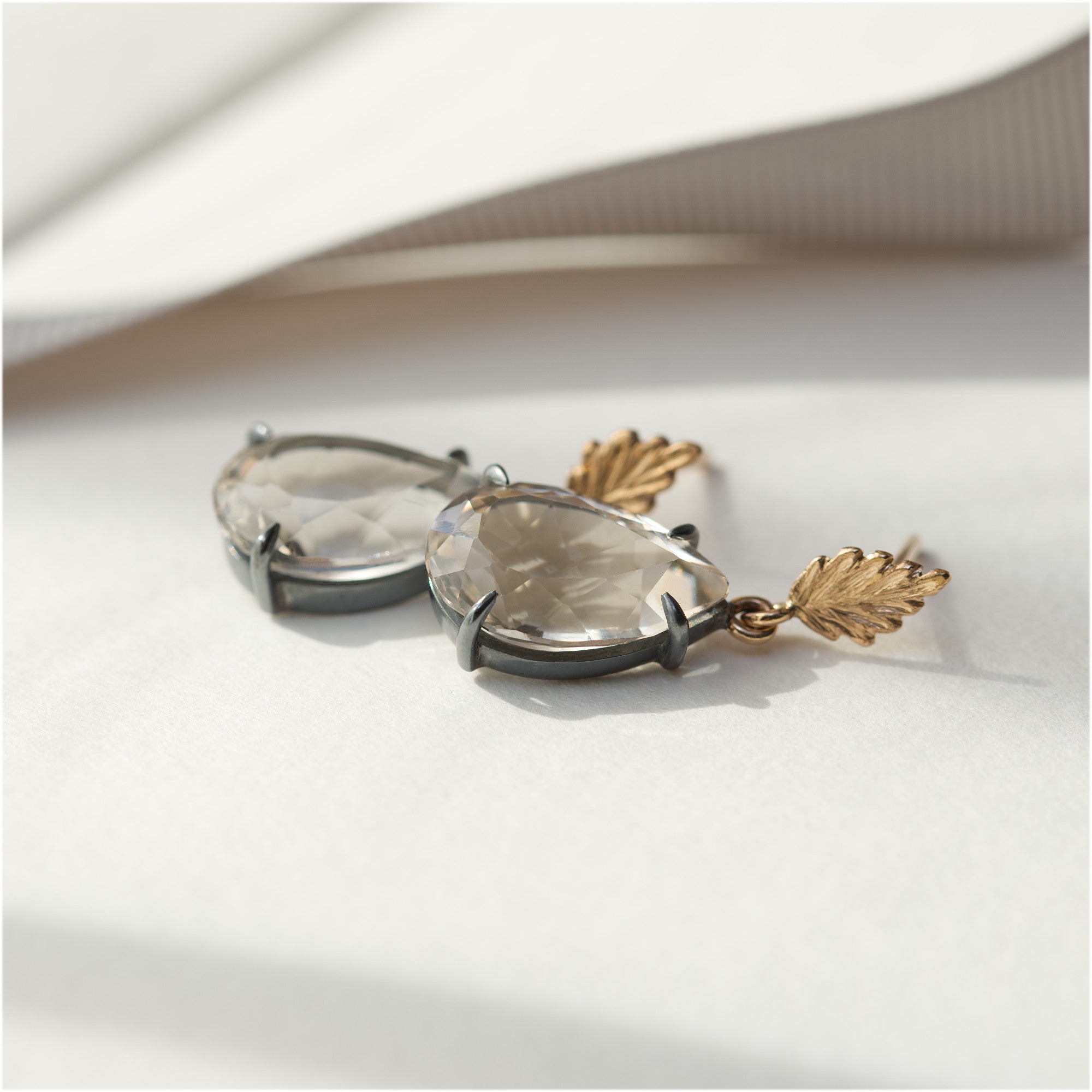 One-of-a-kind 18K gold earrings with blackened silver and white topaz by Ewa Z. Sleziona