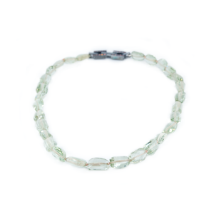 The photo shows a green prasiolite necklace on a white background. The necklace is fully unfolded to properly present the shape of the stones. At the back you can see the necklace's clasp, which is made of blackened silver.