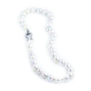 The photo shows a necklace of gray pearls on a white background.