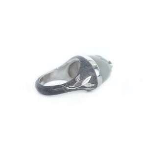 Silver ring with leaf design on a white background