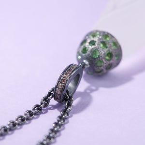 Closeup of the necklace baile set with brown diamonds on a purple background. Necklace made by Ewa Z. Sleziona.