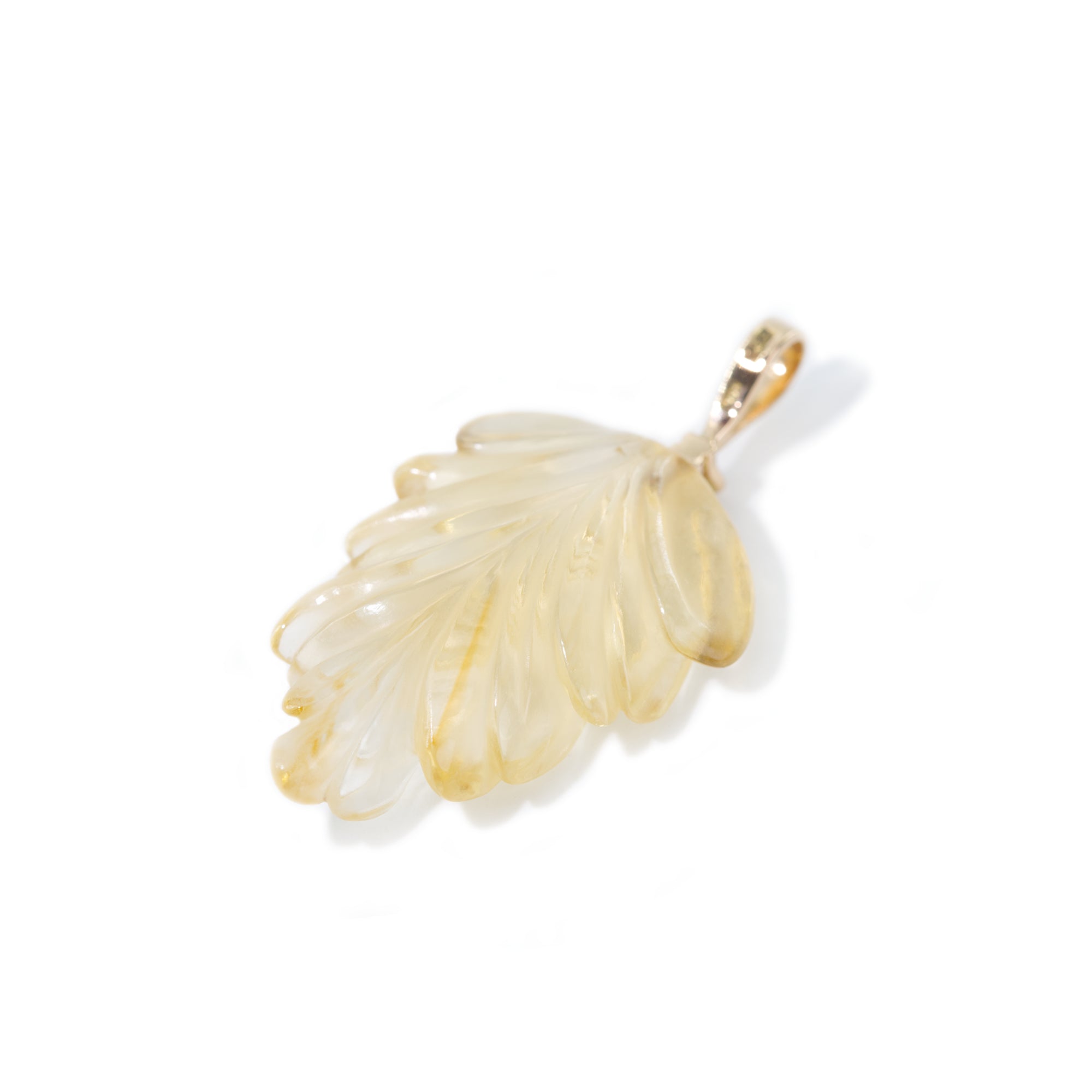 The photo features hand-carved citrine leaf pendant. The pendant is placed on the back side to highlight the detailed work of hand-carving.
